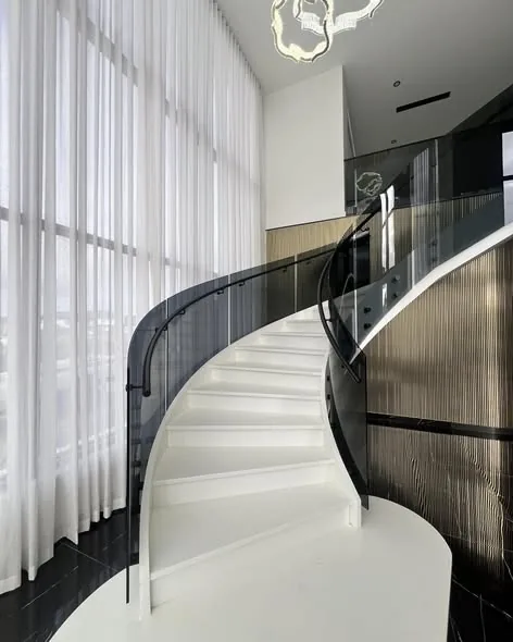Spiral staircase glass with black handrail